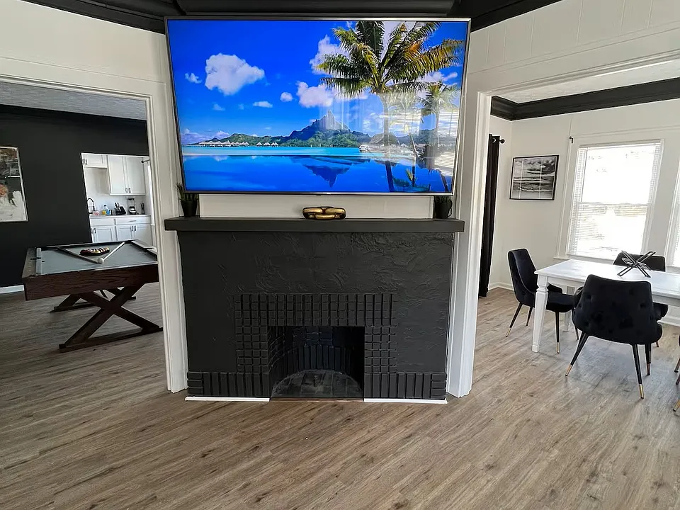 Living room with luxury vinyl floors throughout. Looking towards dining room (left) and bonus room/office (right). Please note unit is NOT furnished