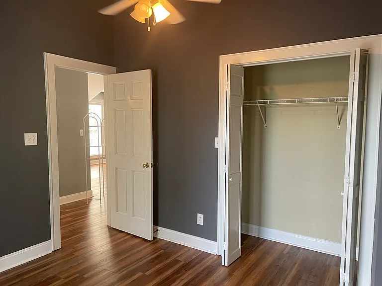 Second bedroom with vaulted ceilings and a large closet. Ceiling fans help keep things cool