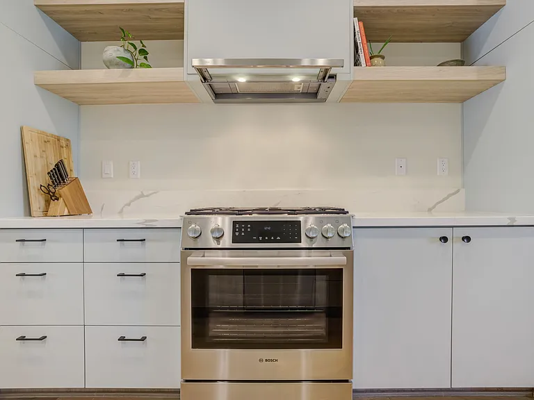 Thoughtfully designed kitchen featuring premium Bosch appliances, quartz countertops, and extensive cabinetry.