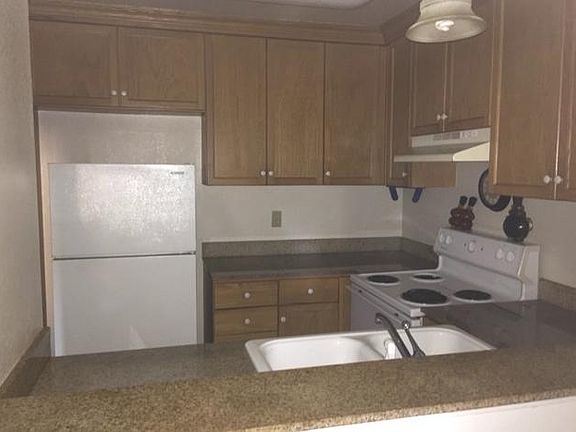 Kitchen with newer appliances and Granite Counters fresh paint and laminate flooring