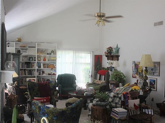Very large living room . Yes, it's  a mess, but the seller is packing to move away. High ceilings! Ceiling fan. Bright natural light. Carpet.