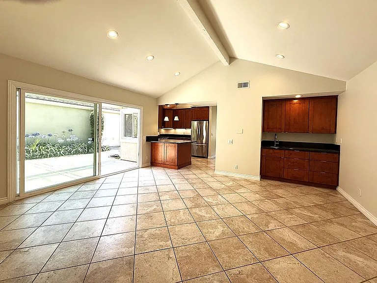 Family room with wet bar and connection to kitchen.