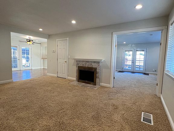 Living room looking into family room also looking into dining area and kitchen