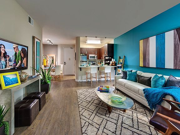 Staged living room with hardwood style vinyl flooring.