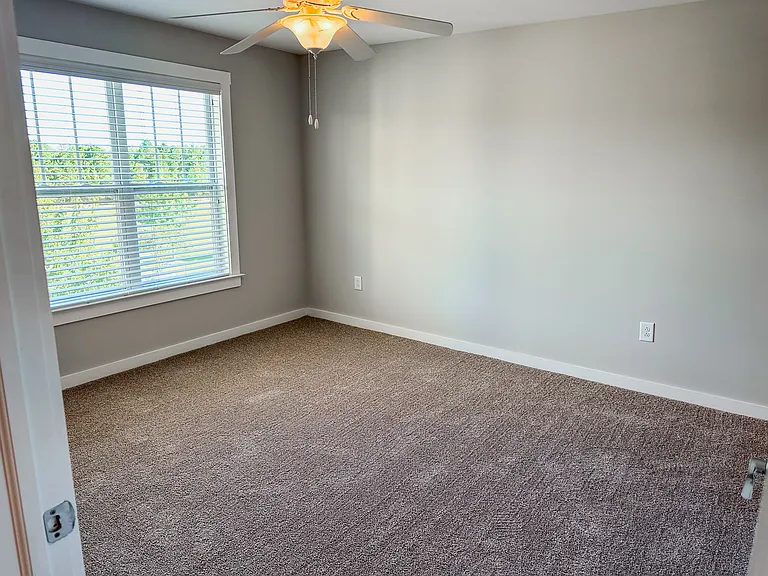 The primary bedroom has an attached walk-in closet and spacious bathroom.