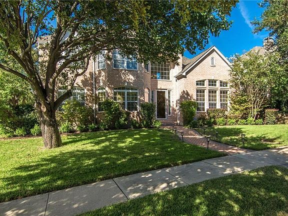 Large, mature trees provide lots of shade in this beautiful front yard.