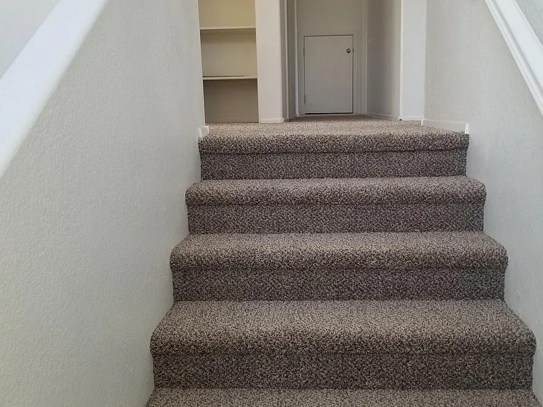 Pic of stair well going to second story. Notice nice hall linen closet. Also notice end of hall small door (yes most will have to bend down) that is the attic storage. Tons of storage.