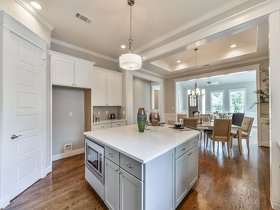 Another perspective of the kitchen with a view of island. Hardwood floors continue throughout the living areas and bedrooms.