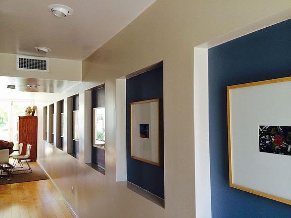 Art niches and custom architectural detail throughout, with a light, modern aesthetic and wood flooring
