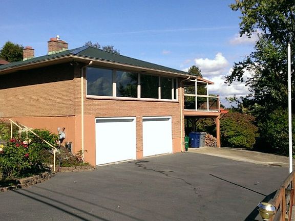 2-car oversized garage PLUS 2 carports including one for covered RV parking. Windows above the garage take full advantage of Sound View!