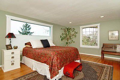 Large Master bedroom with gleaming fir floors and views