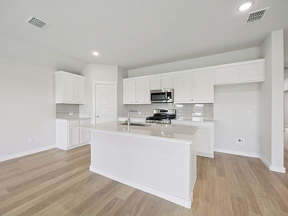 Kitchen in the Hadley home plan by Trophy Signature Homes - REPRESENTATIVE PHOTO