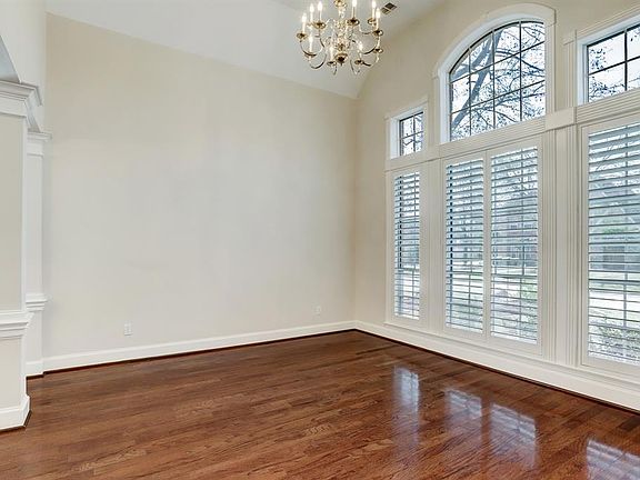 Formal Living connected to Dining overlooks the front yard with plantation shutters in every room of the house.