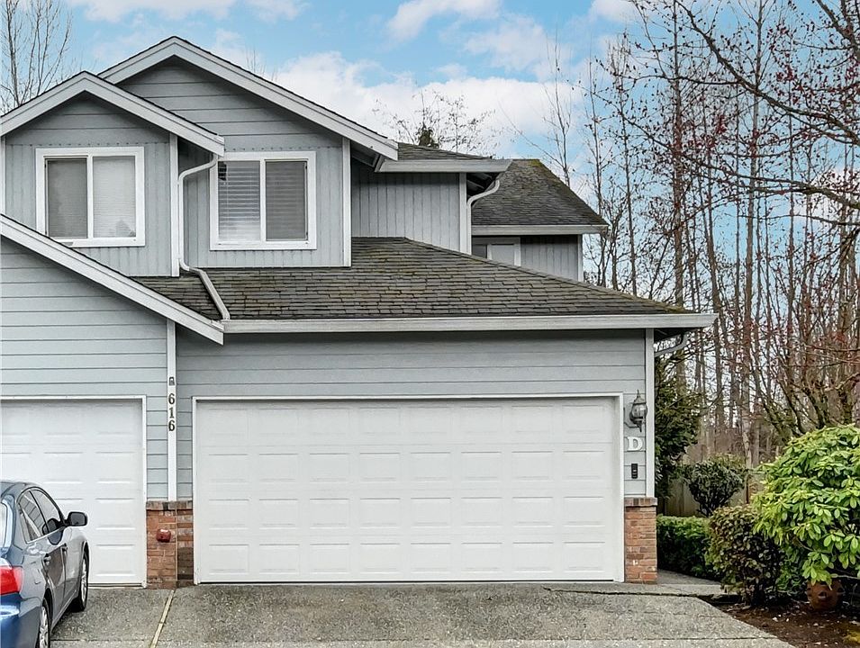 End unit townhouse with only one shared wall provides parking for 4 cars.