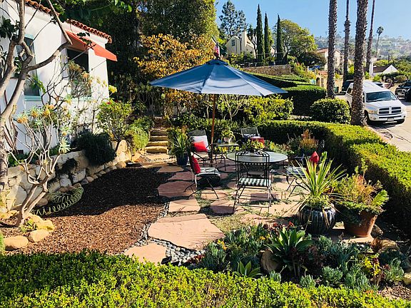 Landscaped front yard with ocean views and seating area with