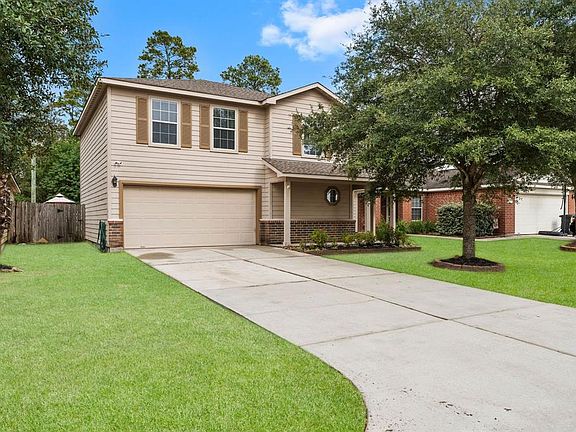 Well-maintained yard with mature trees.