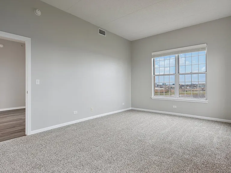 Bedroom with wide window and neutral tones