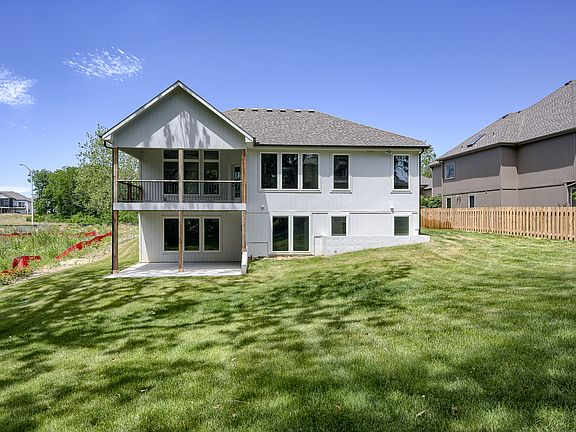 Exterior on a walkout plan with covered deck and patio