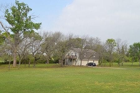view of house on the entry side. The Deck overlooking the Pond is the entry into the living area.