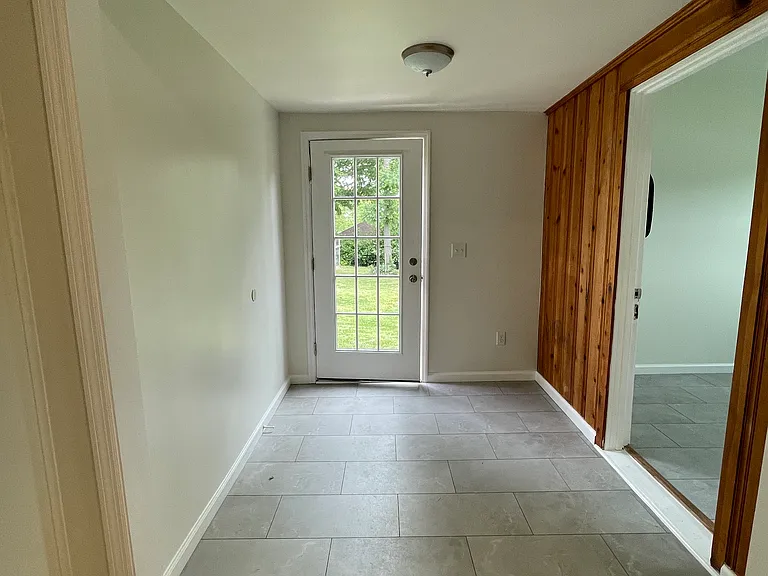 Mudroom off the kitchen on way to laundry or big back yard.