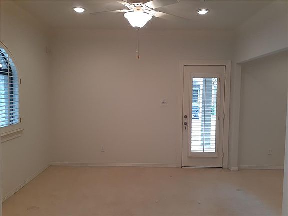 First floor den with door out to the covered patio. Note the plantation shutters. Very large den or add a wall and make a fourth bedroom. Full bath is next to this area.