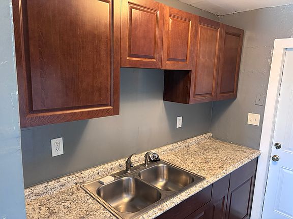Recently renovated kitchen with oak cabinets and dark gray paint