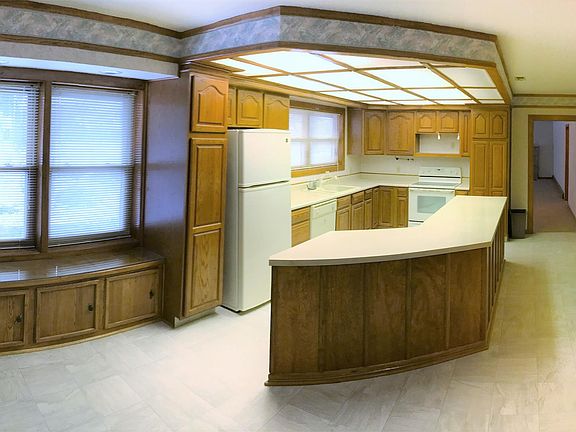 Huge eat in kitchen with custom pull out pantry cabinets.