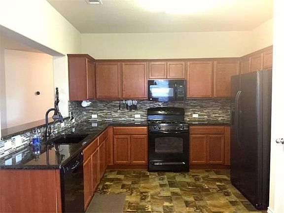 Kitchen has maple cabinets, granite counters and upgraded backsplash