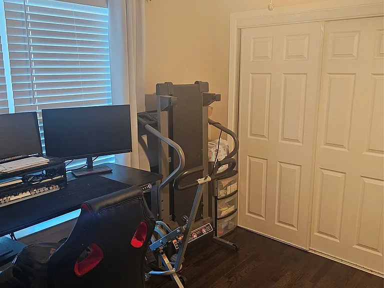 Home office with a ceiling fan and dark wood finished floors