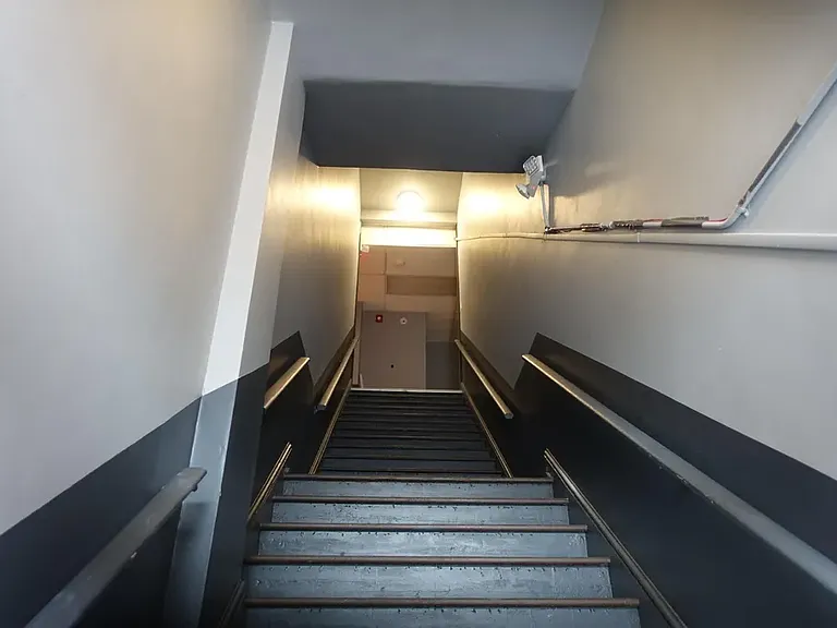 Main staircase to the first floor, second staircase at back of building.