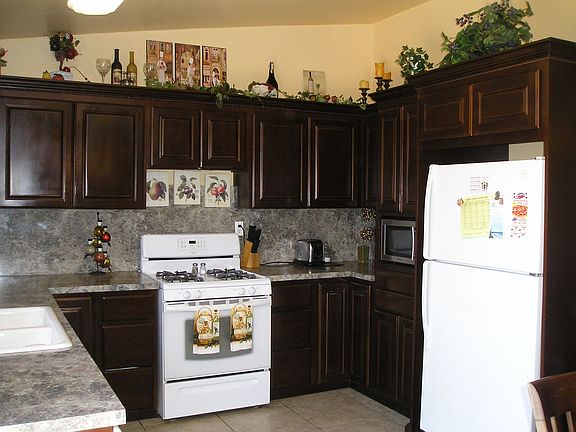 Cabinet encloses refrigerator