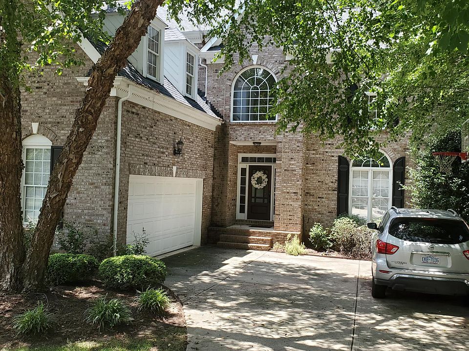 Two car garage with flat drive and basketball goal