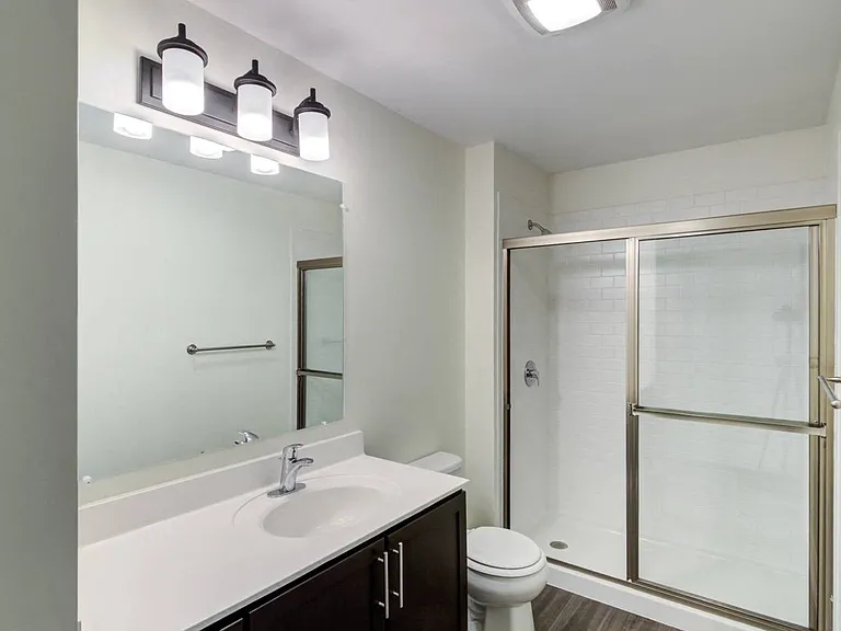 Glass enclosed shower with tile surrounds