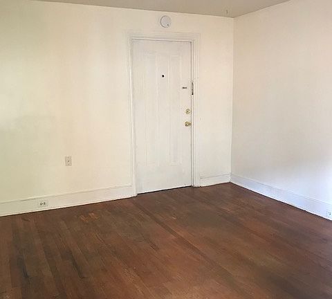 Living room with vintage hardwood floors- lots of windows