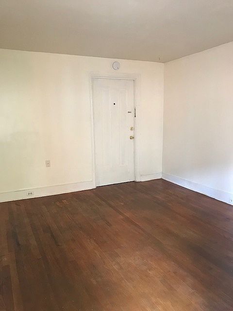 Living room with vintage hardwood floors- lots of windows