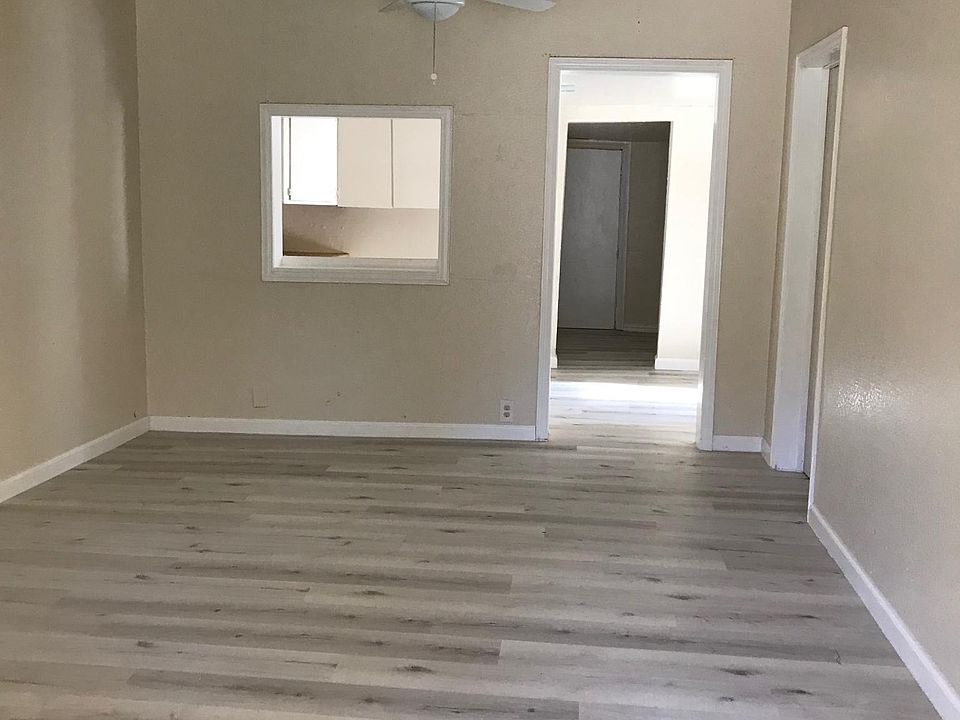 Big living room with two ceiling fans and window AC