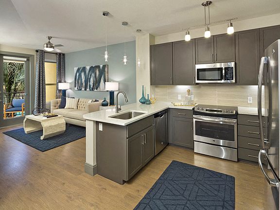 Luxury vinyl plank flooring in entry, kitchen, living and dining rooms
