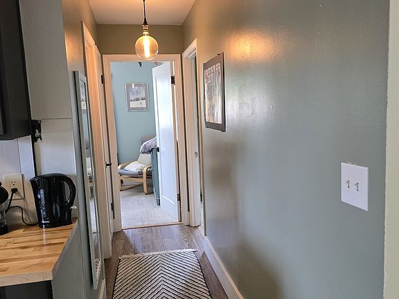 Hallway from kitchen to two bedrooms and full bathroom.