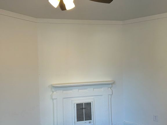 Nice decorative fireplace and new ceiling fan