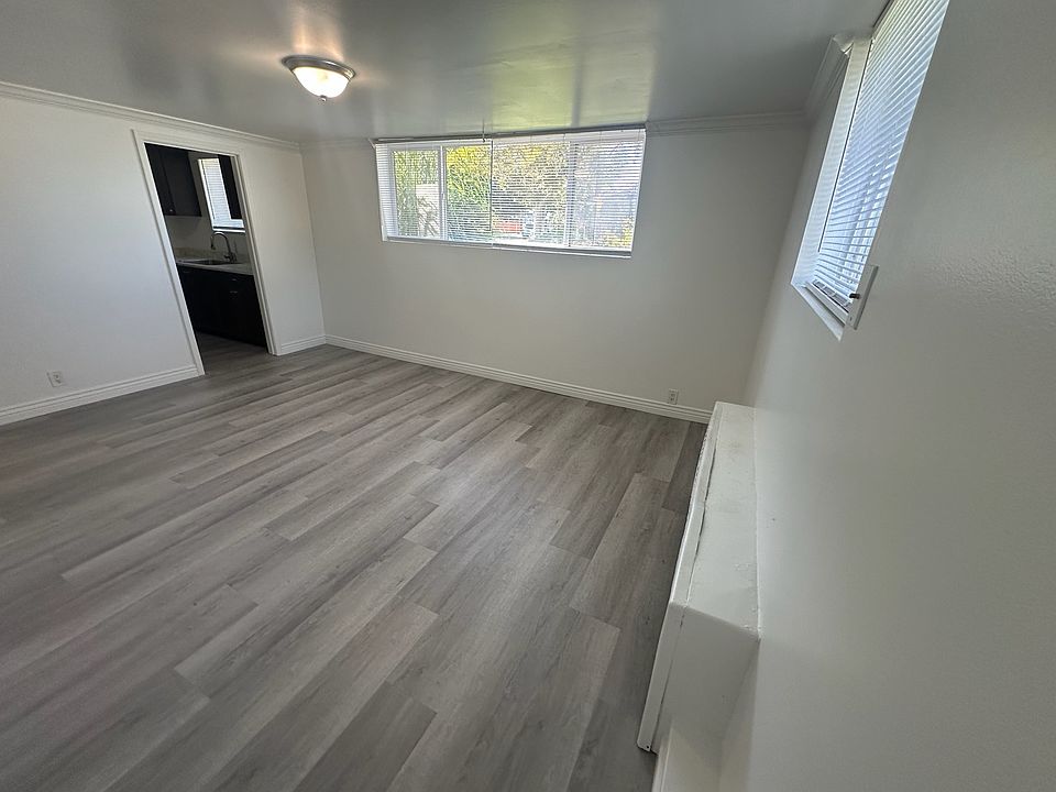 Large Family Room with lots of Natural Light and Brand New Flooring