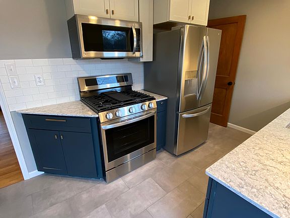 Completely new kitchen with tile floor, solid surface countertops, new stainless appliances and under cabinet lighting!
