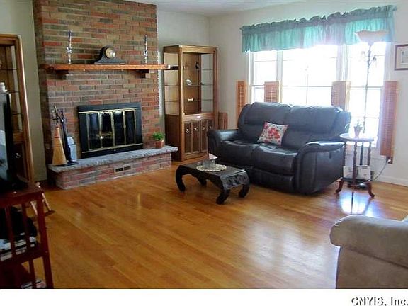 Great Room. This view of the other side of the Great Room shows how generous in size it is and all the natural light streaming in through the triple front windows.