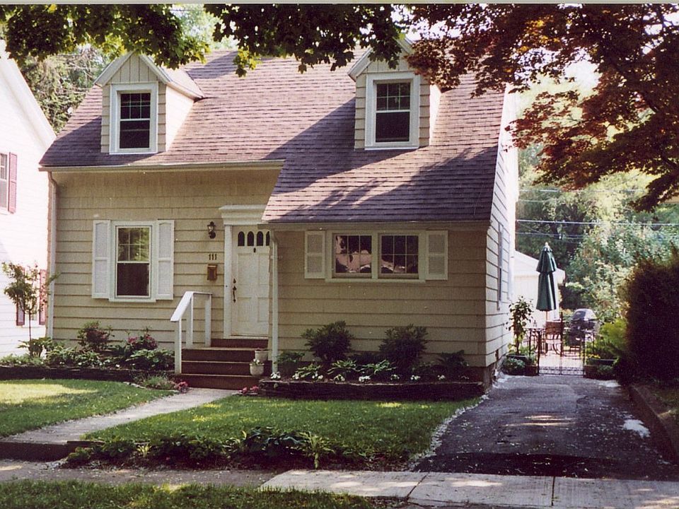 Front of house with rock wall gardens