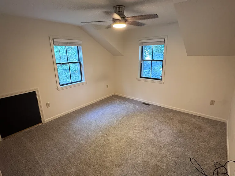 Master Bedroom with access door to attic storage space. Closet located to the left of the black square door
