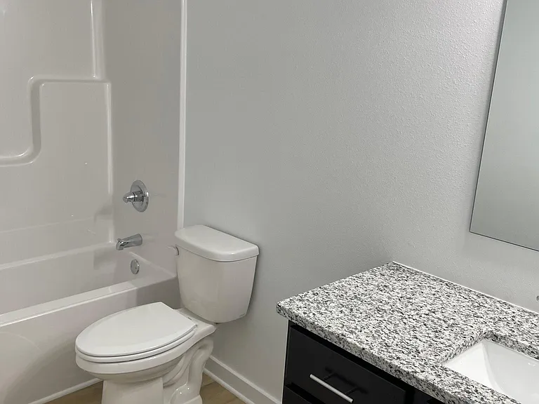 Walk out level bathroom with granite countertop