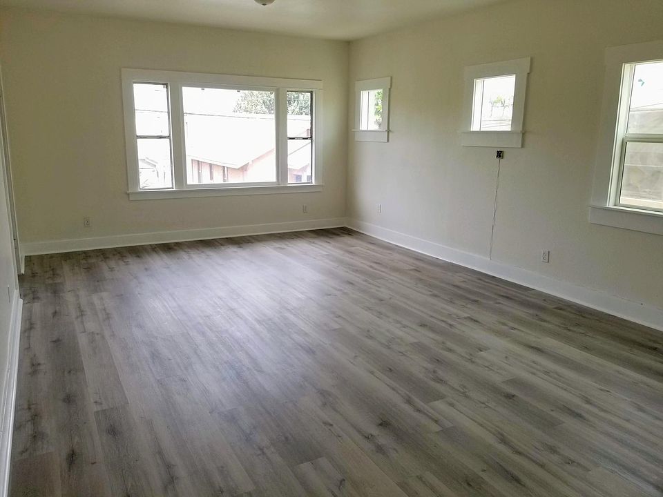 HUGE living room with brand new wood flooring, new windows, and fresh coat of pain. Lots of natural sunlight