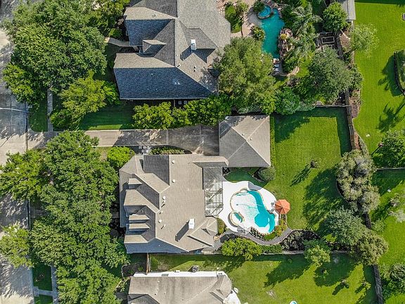 This 1/2 acre (0.485) lot has mature trees and lush landscaping! Look at that pristine roof.