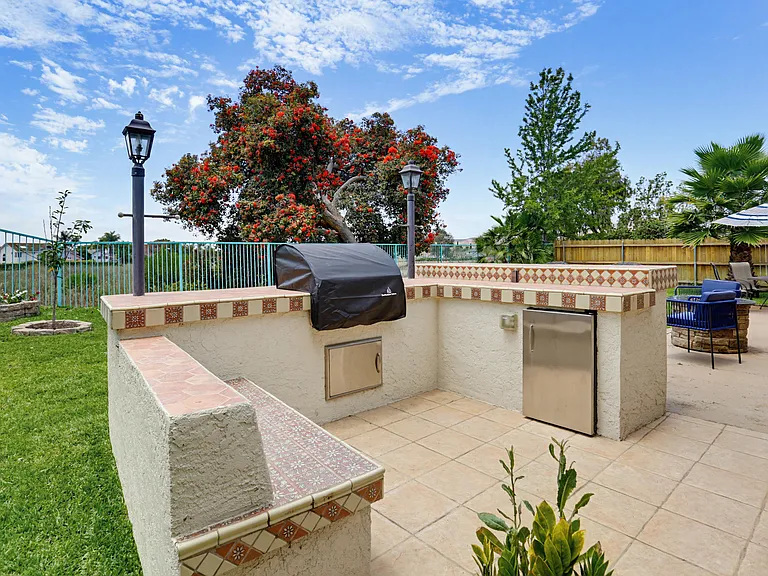 BBQ grill with custom built service and eating area and outdoor refrigerator