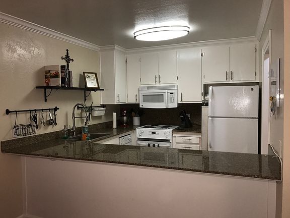 Standing in the living room and looking back to the kitchen.