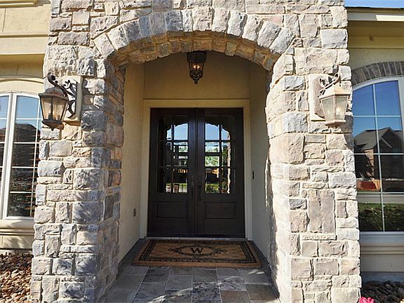 Wow your guests BEFORE they even walk in the door. Gorgeous double doors and slate walkways!